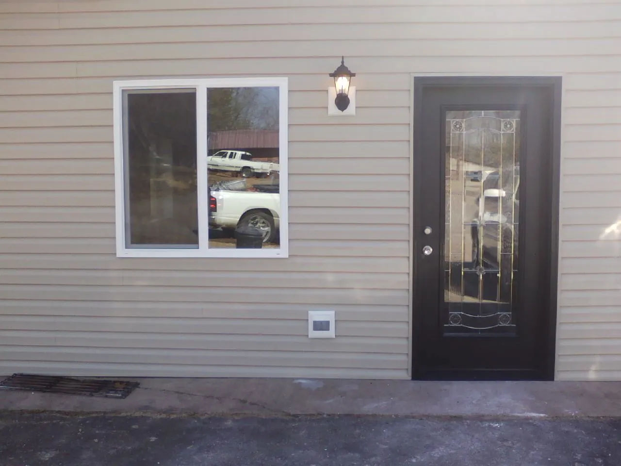 New siding, window and entry door on the side of an addition in Wilmington